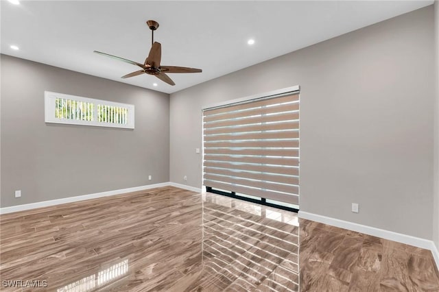 spare room featuring recessed lighting, baseboards, a ceiling fan, and wood finished floors