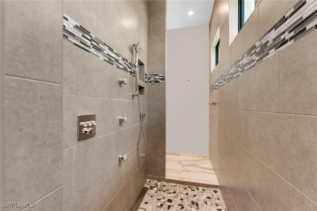 full bathroom with tiled shower