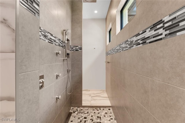 full bathroom with recessed lighting, marble finish floor, and a tile shower