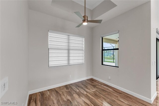 unfurnished room featuring ceiling fan, baseboards, and wood finished floors