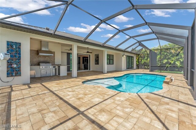 pool with a patio, exterior kitchen, ceiling fan, a lanai, and a grill