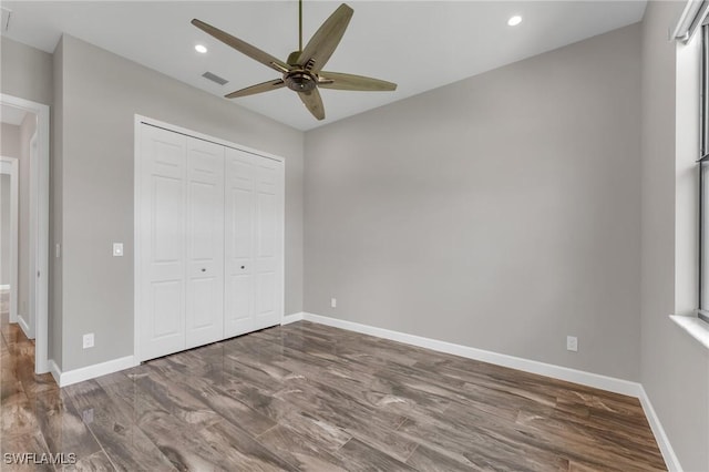 unfurnished bedroom featuring visible vents, baseboards, recessed lighting, wood finished floors, and a closet