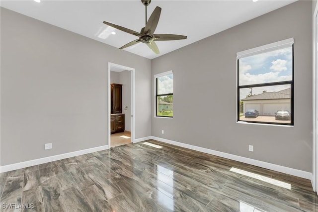 interior space featuring baseboards and ceiling fan