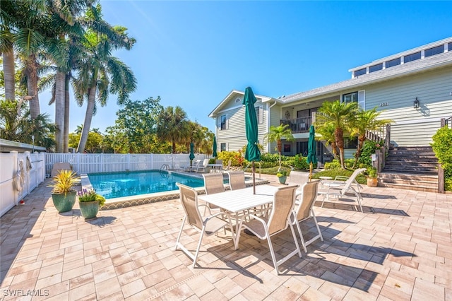 view of swimming pool featuring a fenced in pool, stairway, a fenced backyard, and a patio area