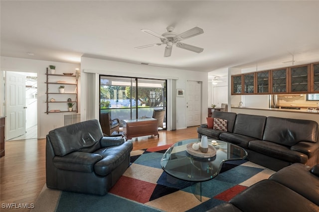 living area featuring wood finished floors and ceiling fan