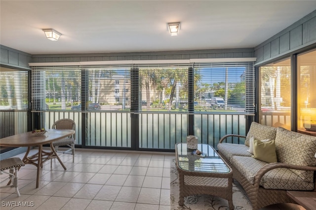 sunroom / solarium featuring a water view