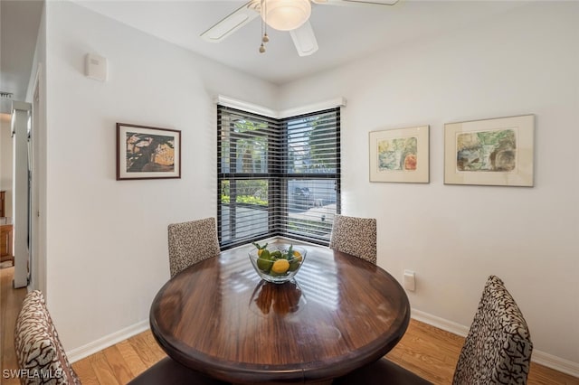 dining space featuring ceiling fan, baseboards, and light wood-style flooring