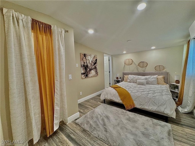 bedroom featuring recessed lighting, baseboards, wood finished floors, and vaulted ceiling