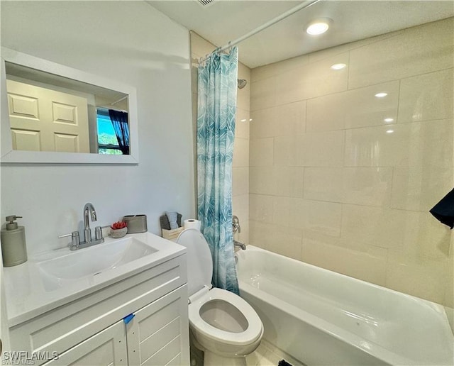 bathroom featuring vanity, shower / bath combination with curtain, and toilet