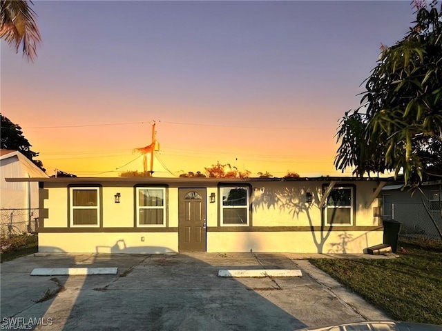 view of front of property with stucco siding and fence