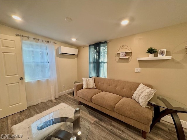 living area with recessed lighting, baseboards, wood finished floors, and a wall mounted AC