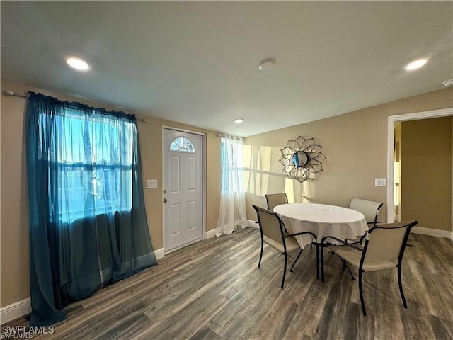 dining room featuring dark wood finished floors, recessed lighting, and baseboards