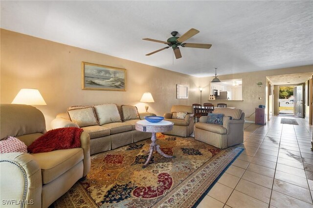 living room with light tile patterned floors and a ceiling fan