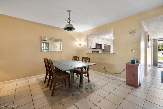dining area with light tile patterned floors and baseboards