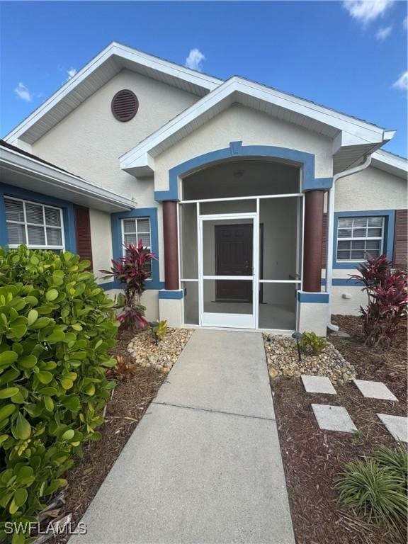 doorway to property with stucco siding