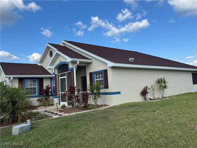 view of property exterior with stucco siding and a yard