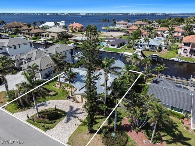 drone / aerial view with a residential view and a water view