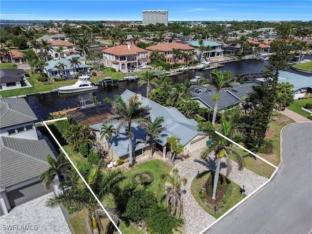 drone / aerial view with a residential view and a water view