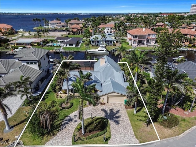 birds eye view of property with a residential view and a water view