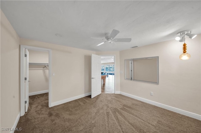 unfurnished bedroom with visible vents, baseboards, carpet, and a spacious closet