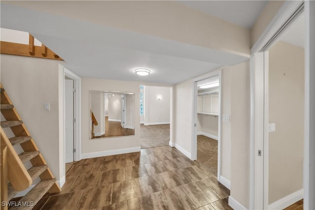 finished basement featuring stairs and baseboards