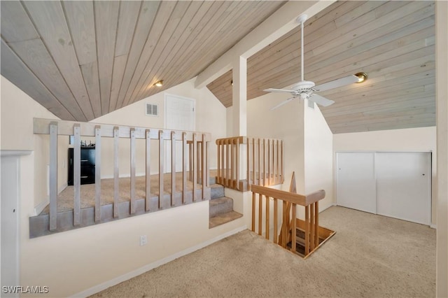 corridor featuring carpet, visible vents, vaulted ceiling with beams, wood ceiling, and an upstairs landing