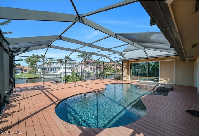 view of swimming pool with glass enclosure, a pool with connected hot tub, and a patio