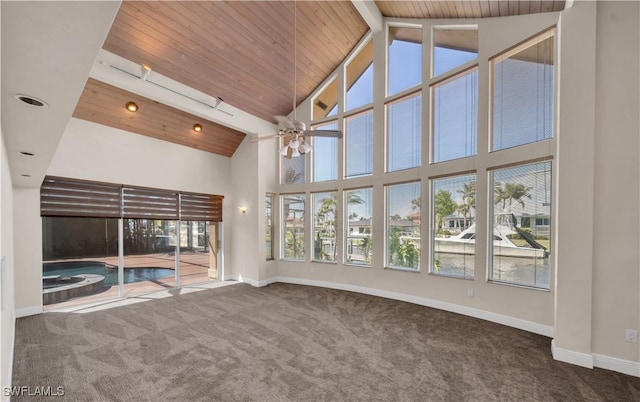 interior space with a ceiling fan, baseboards, high vaulted ceiling, wooden ceiling, and carpet flooring