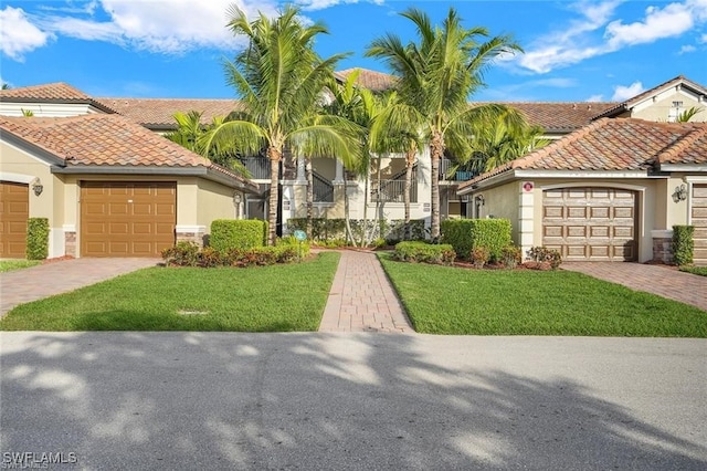 view of front facade featuring stucco siding, decorative driveway, a garage, and a tile roof