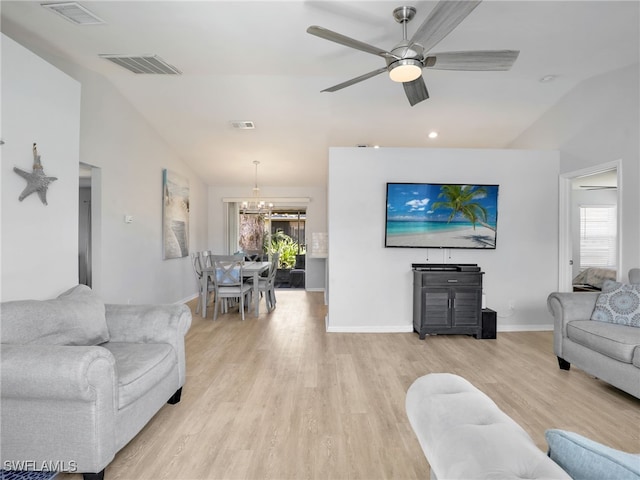 living room featuring lofted ceiling, light wood-style flooring, and visible vents