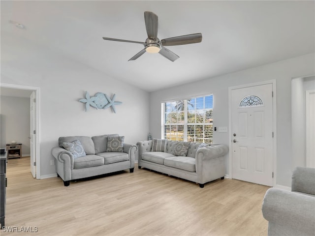 living room featuring lofted ceiling, a ceiling fan, light wood-type flooring, and baseboards