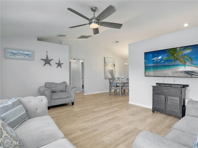 living area with visible vents, lofted ceiling, light wood-type flooring, and ceiling fan