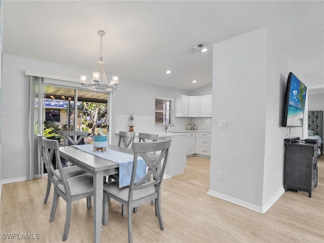 dining area featuring visible vents, baseboards, light wood-type flooring, recessed lighting, and a notable chandelier