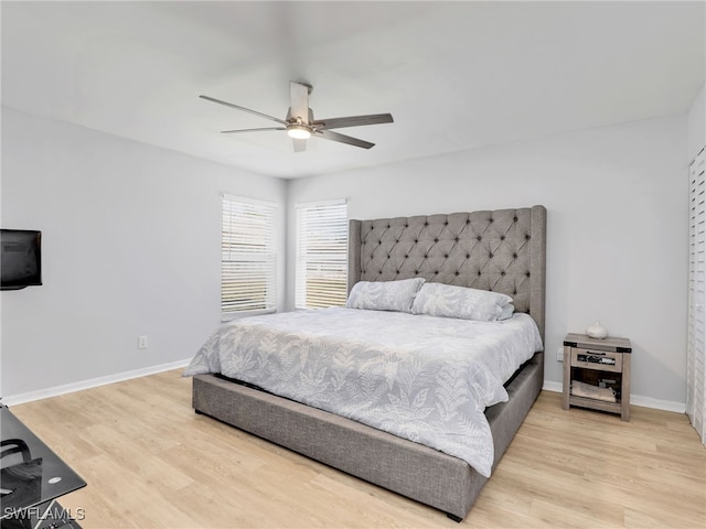 bedroom with a ceiling fan, light wood-style floors, and baseboards