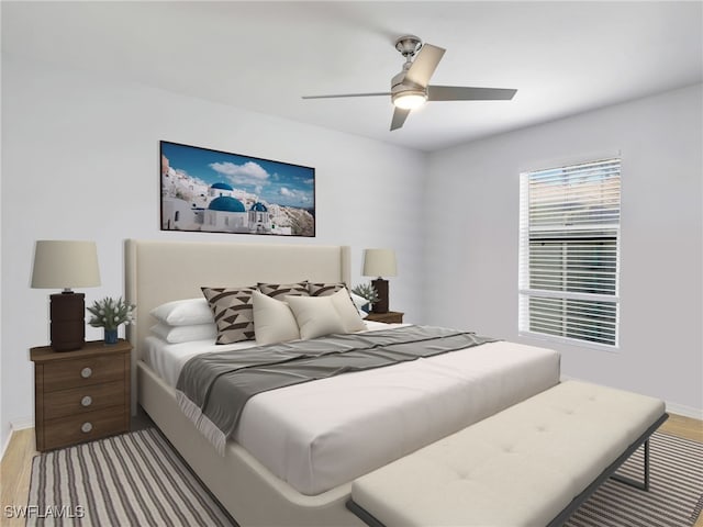 bedroom featuring baseboards, wood finished floors, and a ceiling fan