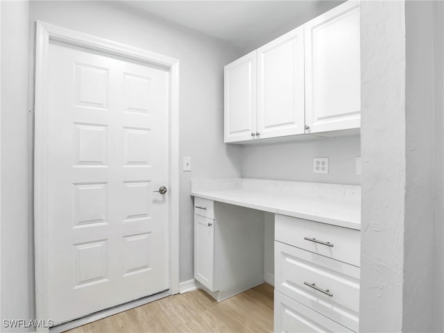 interior space with baseboards and light wood-style floors