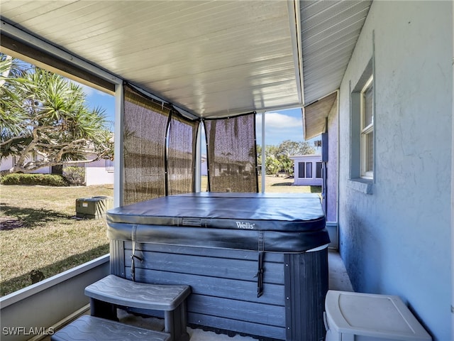 wooden deck featuring a hot tub