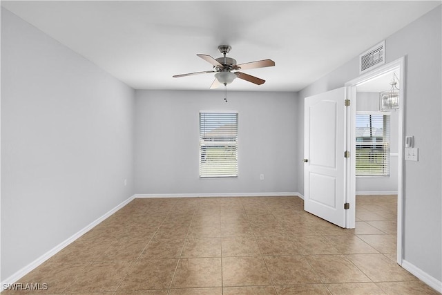 821 Casino Ave, Lehigh Acres, FL 33971 - unfurnished room featuring healthy amount of natural light, a ceiling fan, light tile patterned flooring, and baseboards