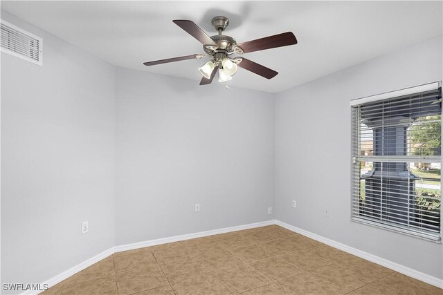 821 Casino Ave, Lehigh Acres, FL 33971 - spare room featuring baseboards, a ceiling fan, and tile patterned floors
