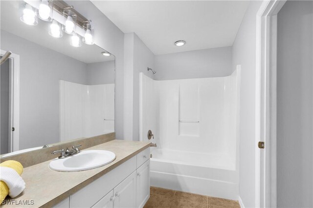 821 Casino Ave, Lehigh Acres, FL 33971 - bathroom with vanity, washtub / shower combination, and tile patterned flooring