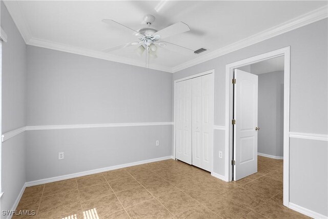821 Casino Ave, Lehigh Acres, FL 33971 - unfurnished bedroom with a closet, ornamental molding, baseboards, ceiling fan, and tile patterned flooring