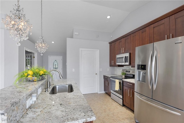 821 Casino Ave, Lehigh Acres, FL 33971 - kitchen featuring stainless steel appliances, a sink, a chandelier, light tile patterned flooring, and decorative light fixtures