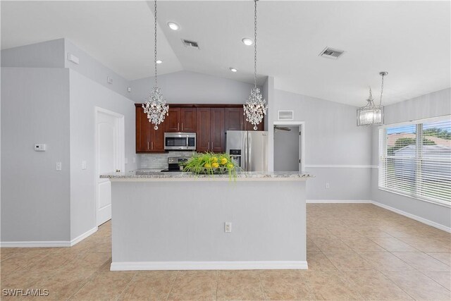 821 Casino Ave, Lehigh Acres, FL 33971 - kitchen featuring stainless steel appliances, a chandelier, vaulted ceiling, light tile patterned floors, and decorative backsplash