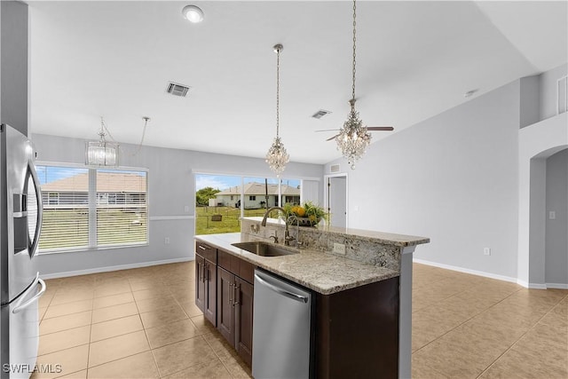 821 Casino Ave, Lehigh Acres, FL 33971 - kitchen with stainless steel appliances, a sink, a chandelier, and light tile patterned flooring