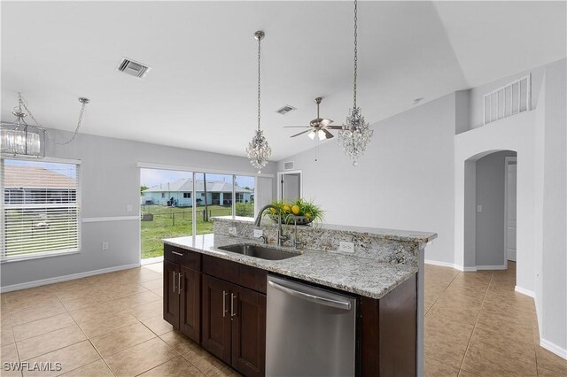821 Casino Ave, Lehigh Acres, FL 33971 - kitchen with stainless steel dishwasher, a sink, ceiling fan, light tile patterned floors, and arched walkways