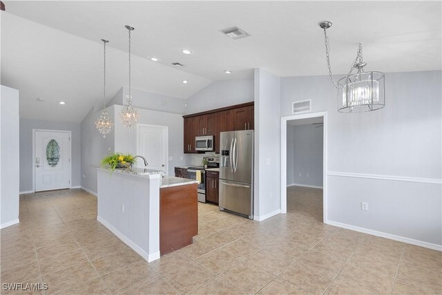 821 Casino Ave, Lehigh Acres, FL 33971 - kitchen featuring stainless steel appliances, a chandelier, light tile patterned flooring, a peninsula, and high vaulted ceiling