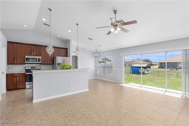821 Casino Ave, Lehigh Acres, FL 33971 - kitchen with appliances with stainless steel finishes, vaulted ceiling, light tile patterned floors, tasteful backsplash, and light countertops