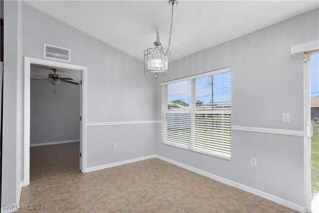 821 Casino Ave, Lehigh Acres, FL 33971 - tiled empty room featuring a chandelier, baseboards, and ceiling fan