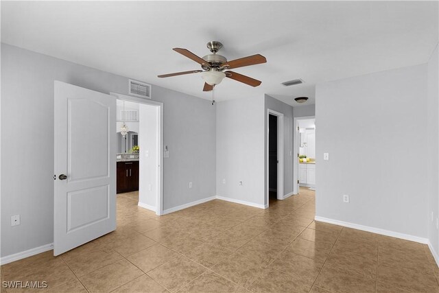 821 Casino Ave, Lehigh Acres, FL 33971 - spare room featuring a ceiling fan, baseboards, and light tile patterned flooring