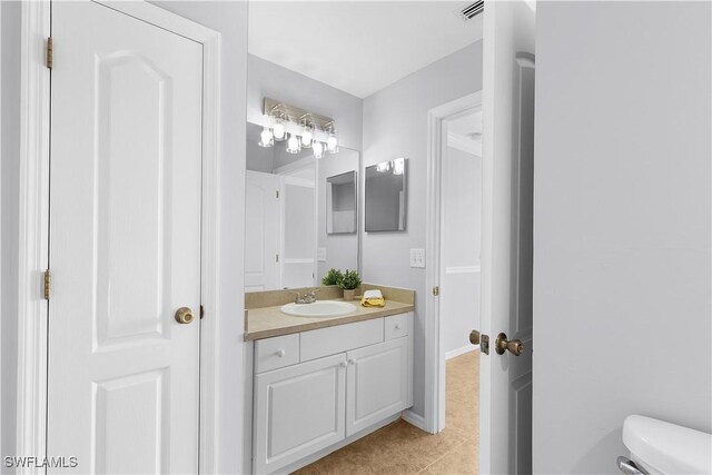 821 Casino Ave, Lehigh Acres, FL 33971 - bathroom with vanity, tile patterned flooring, toilet, and baseboards
